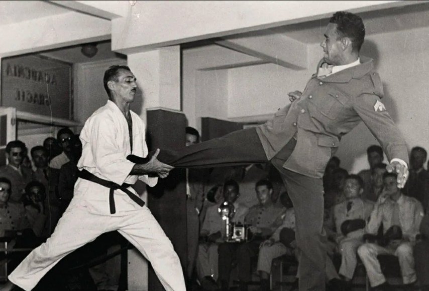 Grand Master Hélio Gracie deflecting a kick during a self-defense demonstration